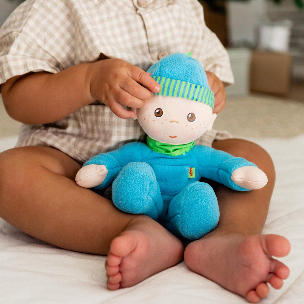 HABA Luis plush doll with printed facial features for safe newborn toy.