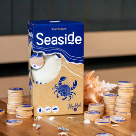 Hachette Seaside game shows players stacking token towers during play.