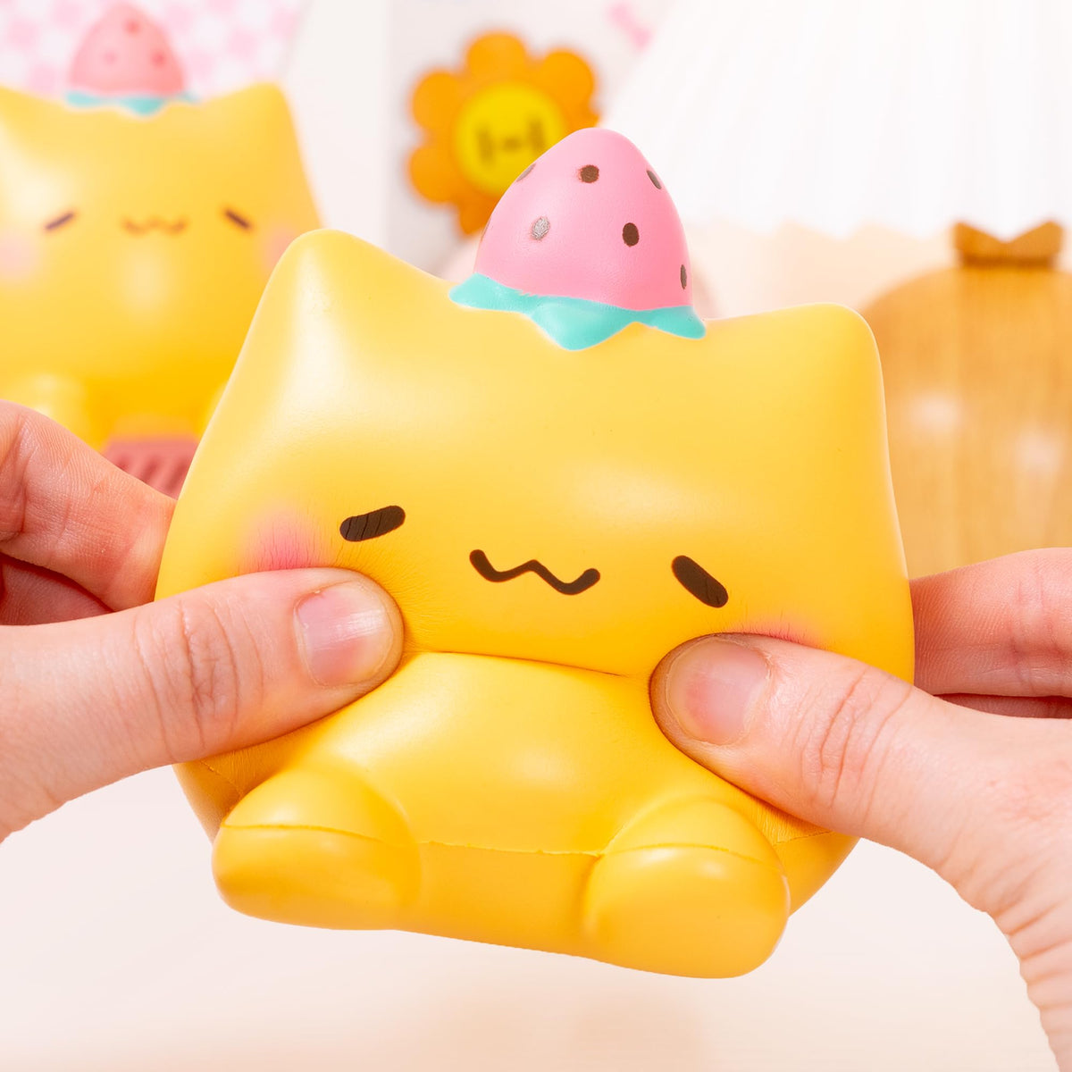 Hands holding the jumbo cat squishy, showcasing durable, gentle texture.