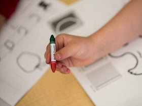 Handwriting Without Tears color-in-action shot highlights vibrant colors and flipping fun.