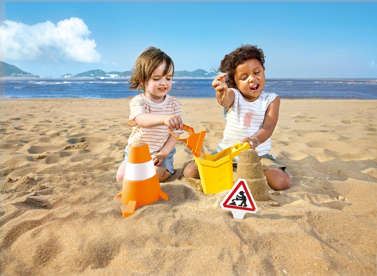 Hape construction sand toy set promotes outdoor social play.