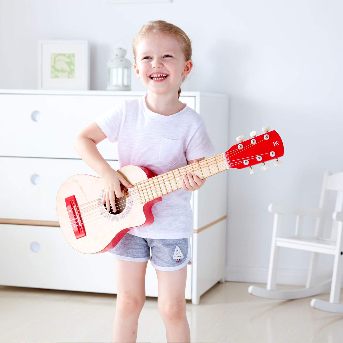 Hape Flame First Guitar 26-inch red front view showing tunable nylon strings
