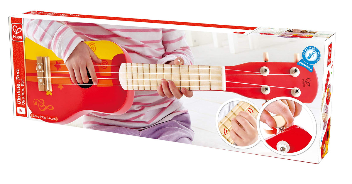 Hape Kid's wooden ukulele red in hand, easy for kids to grip