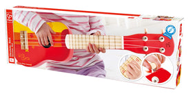 Hape Kid's wooden ukulele red in hand, easy for kids to grip