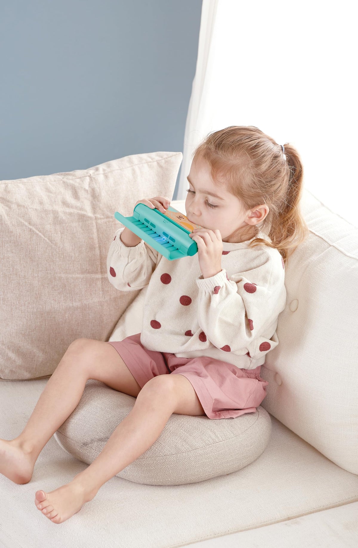 Hape harmonica connected to light-up play panel guides learning with colors.