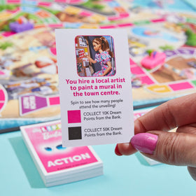 Hasbro The Game of Life Barbie Edition Malibu board; adds a beachy atmosphere to gameplay.