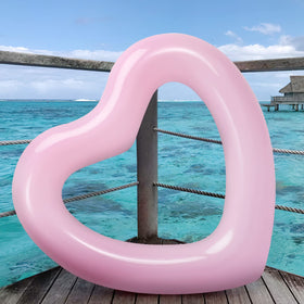 HeySplash pink heart float supports relaxed lounging under sunlit water