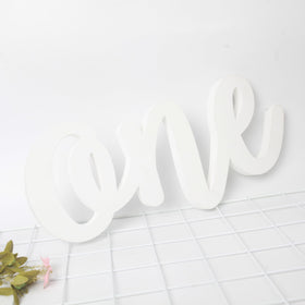 HGFC Wooden One Sign party setup beside gifts and confetti.