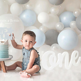 HGFC Wooden One Sign table display setting with balloons and cake.