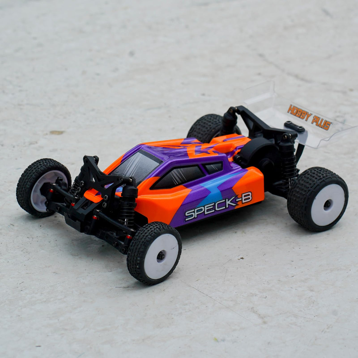 HOBBYPLUS Speck B 1/24 RC buggy in high-speed action with agile handling.