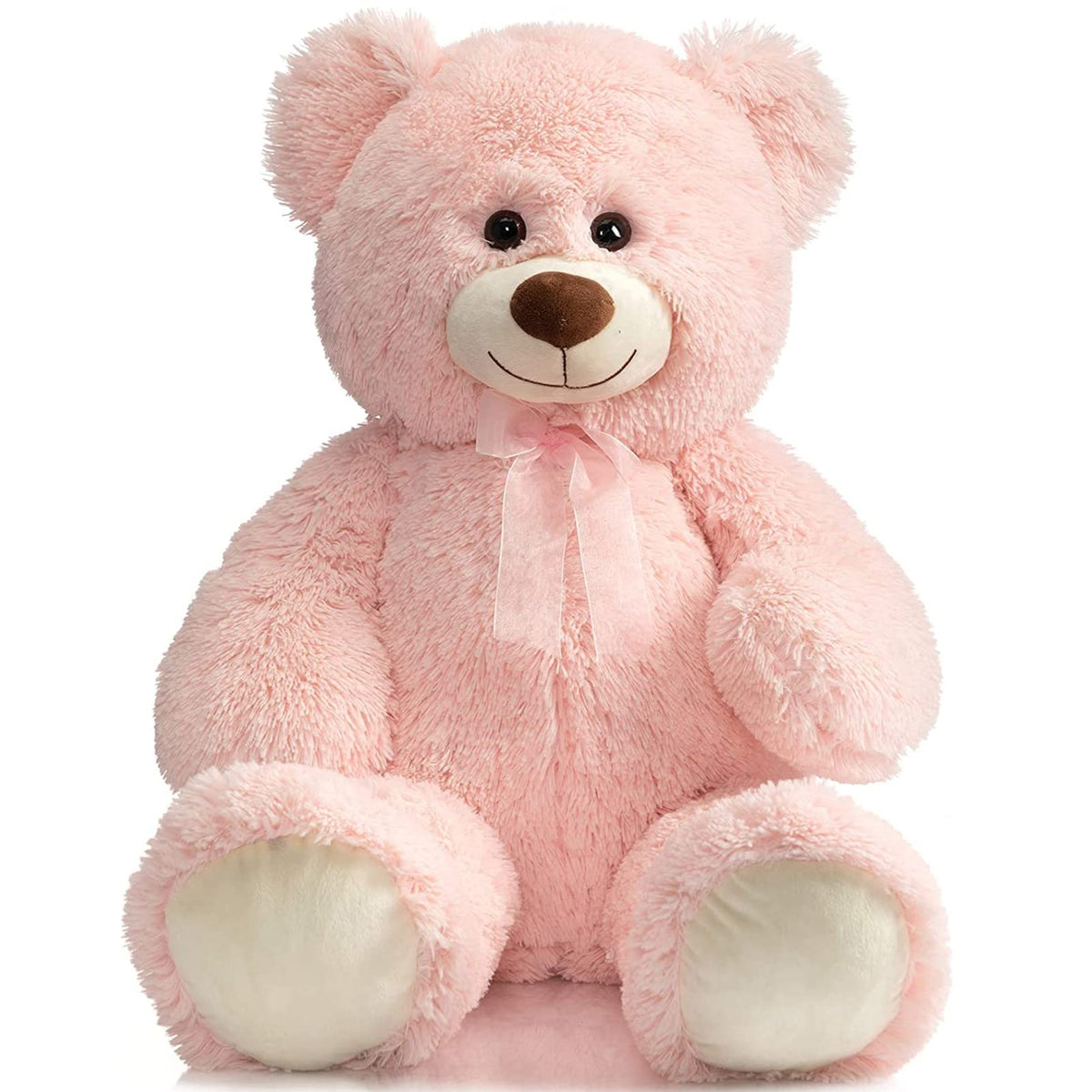 HollyHOME 36-inch pink teddy bear beside a bed for cozy bedside snuggling.