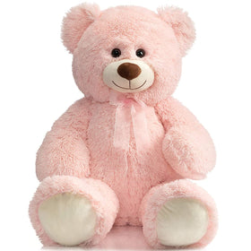 HollyHOME 36-inch pink teddy bear beside a bed for cozy bedside snuggling.