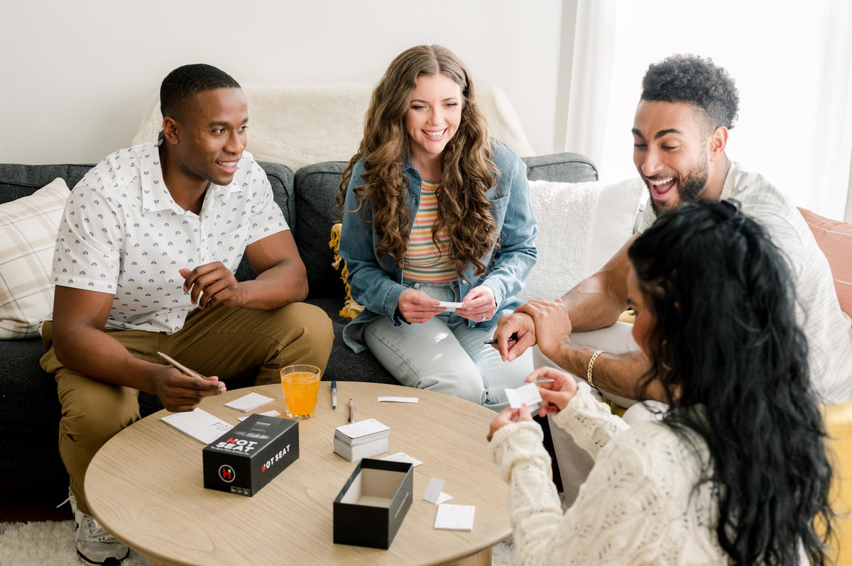 Hot Seat family game night setup with friends around a table for laughs
