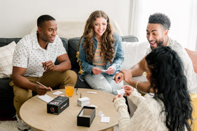 Hot Seat family game night setup with friends around a table for laughs
