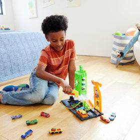 Hot Wheels Super Recharge hose-station activation triggers launchers and car lift for dynamic play