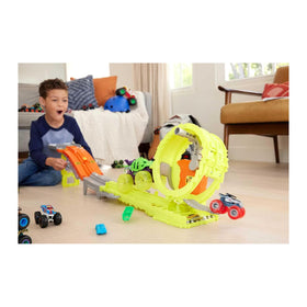 Two trucks race down a hill toward a loop, released by a simple switch.