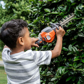 Husqvarna 122HD45 toy hedge trimmer battery compartment with batteries not included.