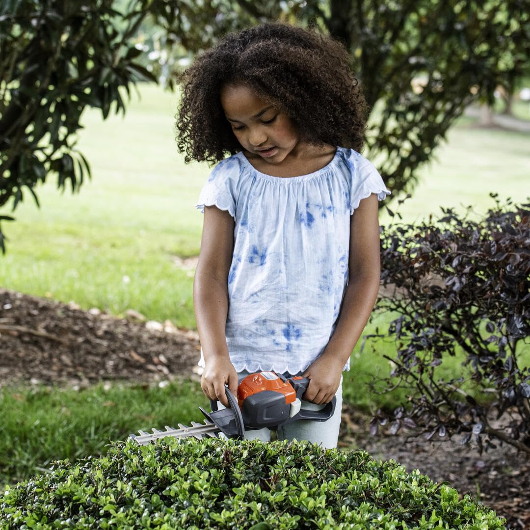 Close-up of the Husqvarna 122HD45 toy hedge trimmer grip for comfortable pretend play.