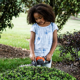 Close-up of the Husqvarna 122HD45 toy hedge trimmer grip for comfortable pretend play.