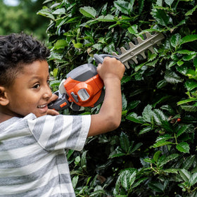 Husqvarna 122HD45 toy hedge trimmer imitation cutters in motion.