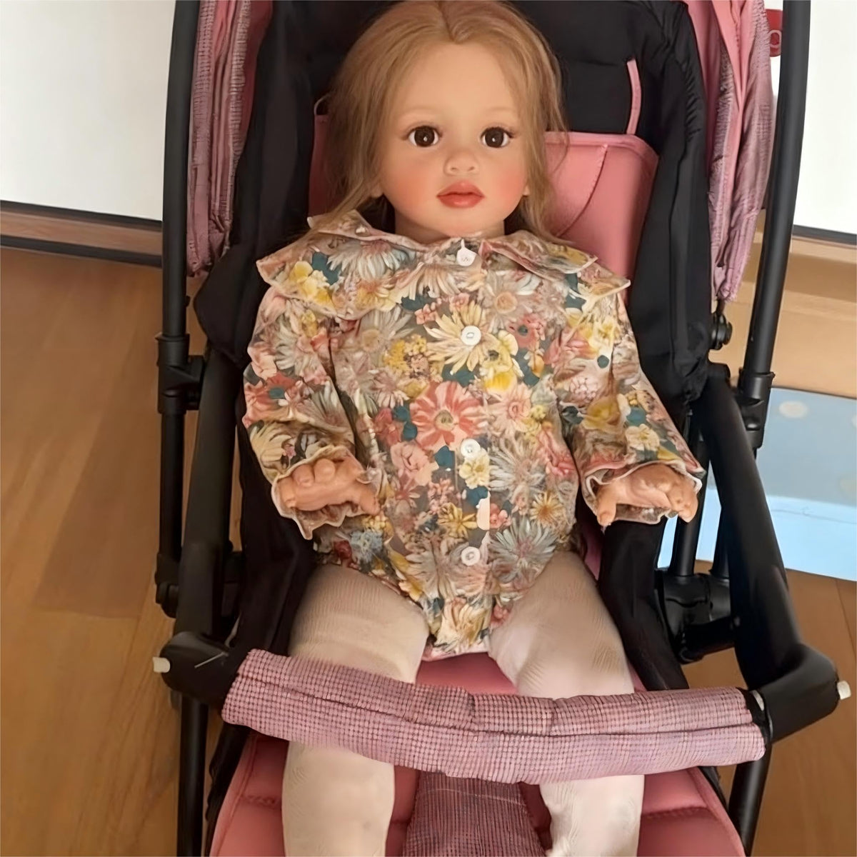 iCradle packaging includes doll, clothes, pacifier, bottle, and birth certificate