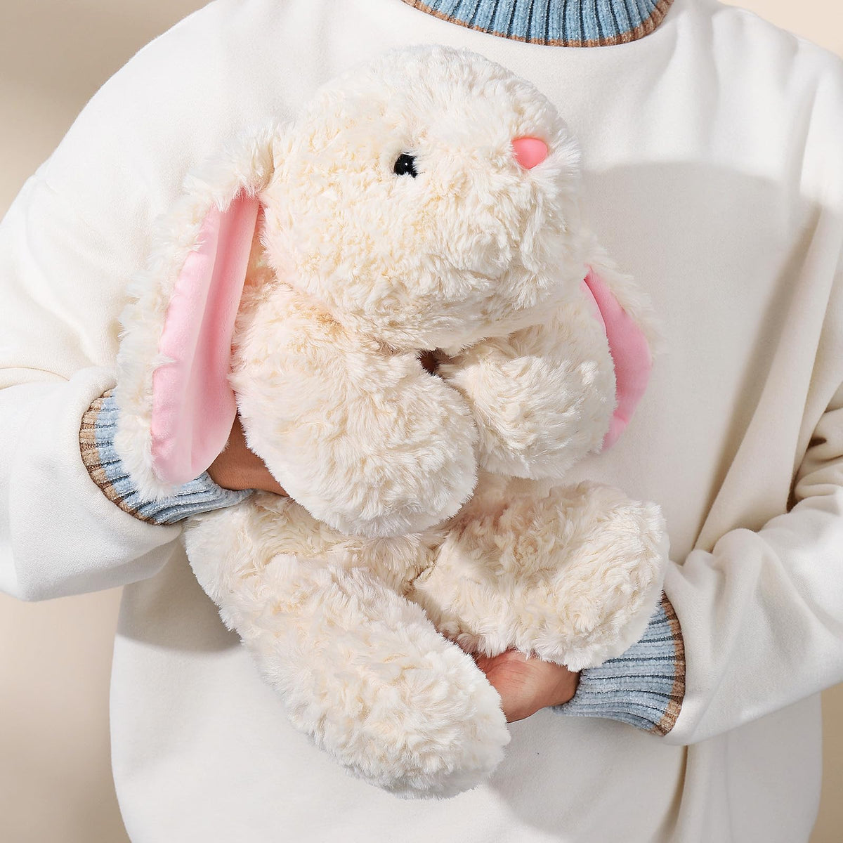 IFX24 weighted rabbit toy in beige used as a hugging pillow for comfort