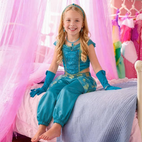 IKALI dress bodice close-up highlights glitter and gold trim sparkle.