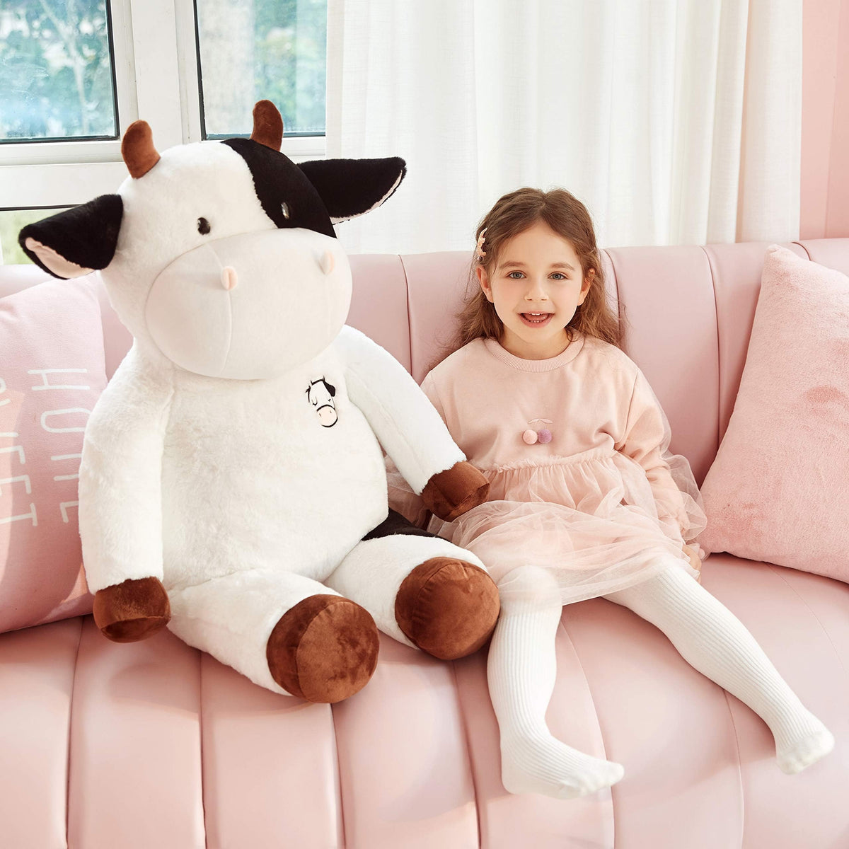IKASA giant cow plush close-up showing ultra-soft fur texture.