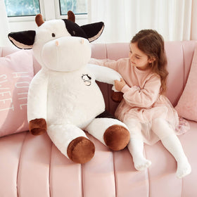 IKASA giant cow used as a decor accent in a cozy bedroom.