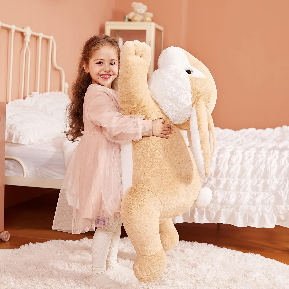 IKASA giant rabbit plush being hugged by a child, perfect gift moment.