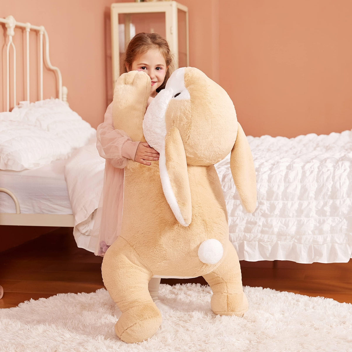 IKASA giant rabbit plush with scale beside an adult, shows size.