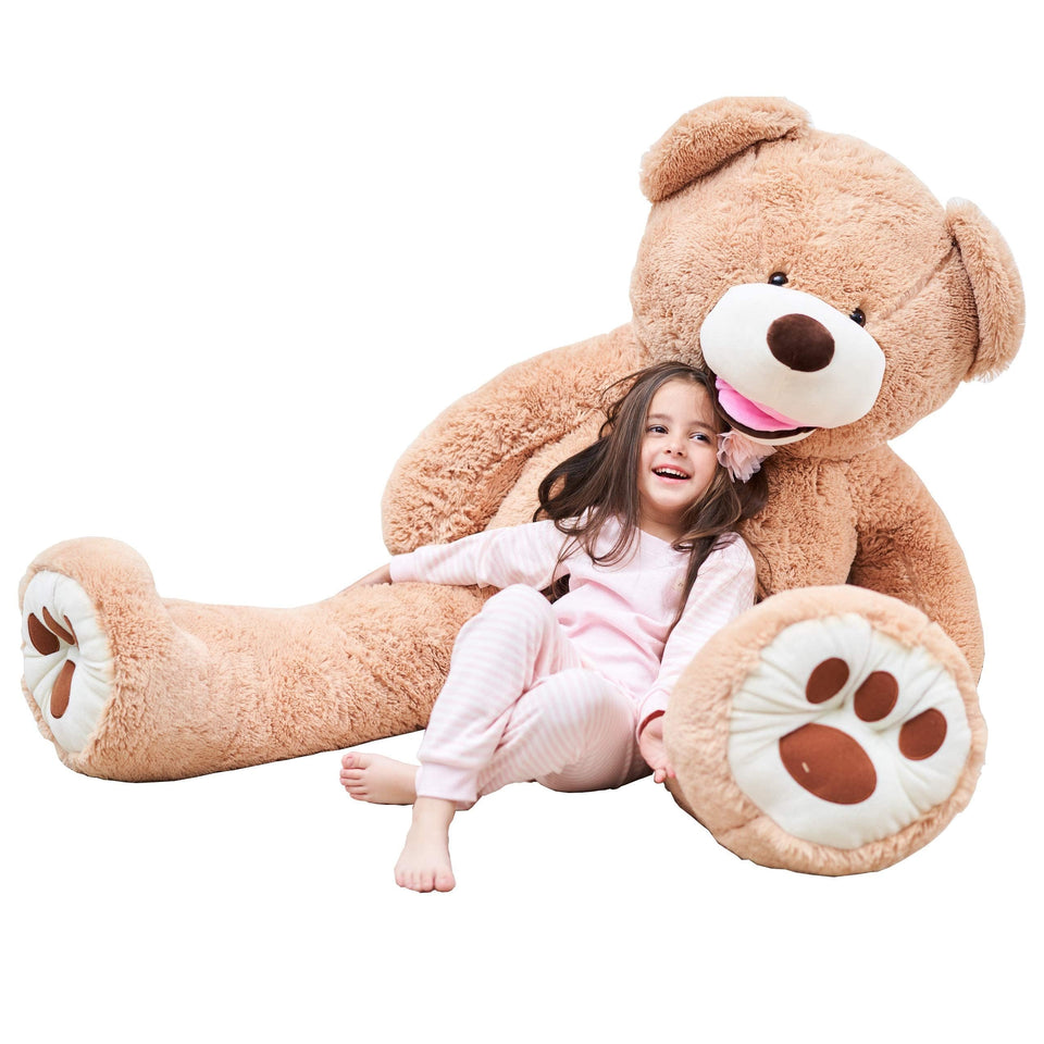 IKASA giant teddy bear standing 63 inches tall, perfect for cozy room decor and cuddle moments.