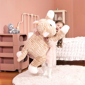 IKASA orange plush shown as bedtime companion and photo prop