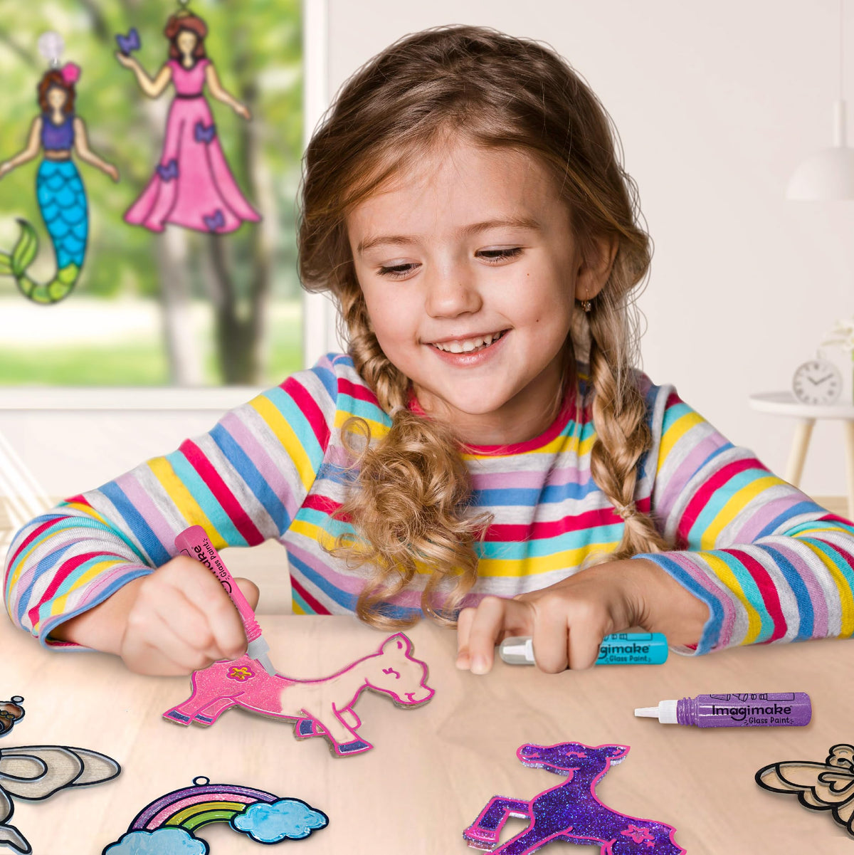 Imagimake Glitter paint tubes add sparkle to window art projects.