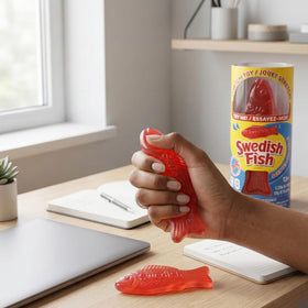 Incredible Group Swedish Fish scented squishy stretched to demonstrate elasticity.