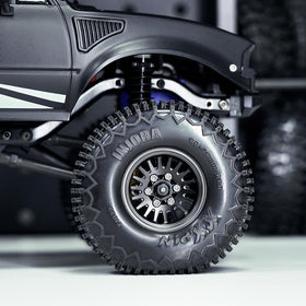 INJORA 1.0 Plus brass beadlock wheel rim mounted on RC crawler enhances stance and grip.