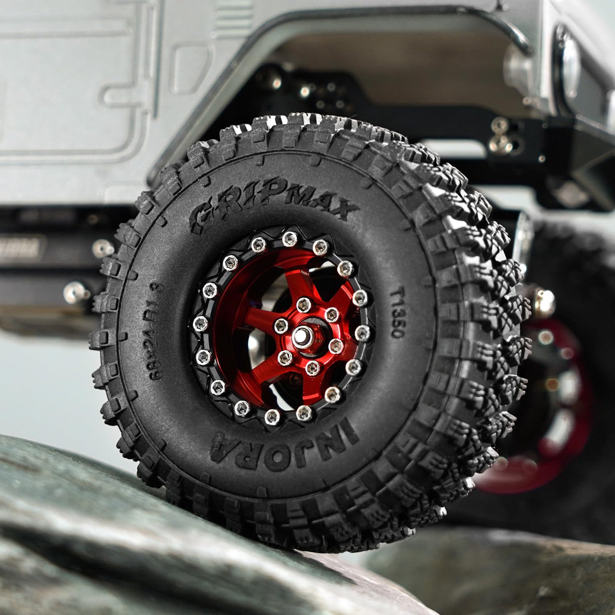 Red INJORA wheel mounted on a SCX24 chassis for wider track stability.