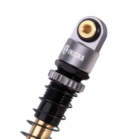 INJORA 43mm aluminum shocks in action on a SCX24 demonstrate enhanced stability.