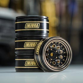 Close-up of INJORA brass wheel showing durable coating and brass texture.