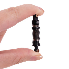 INJORA big bore shock assembly close-up emphasizing dampening design
