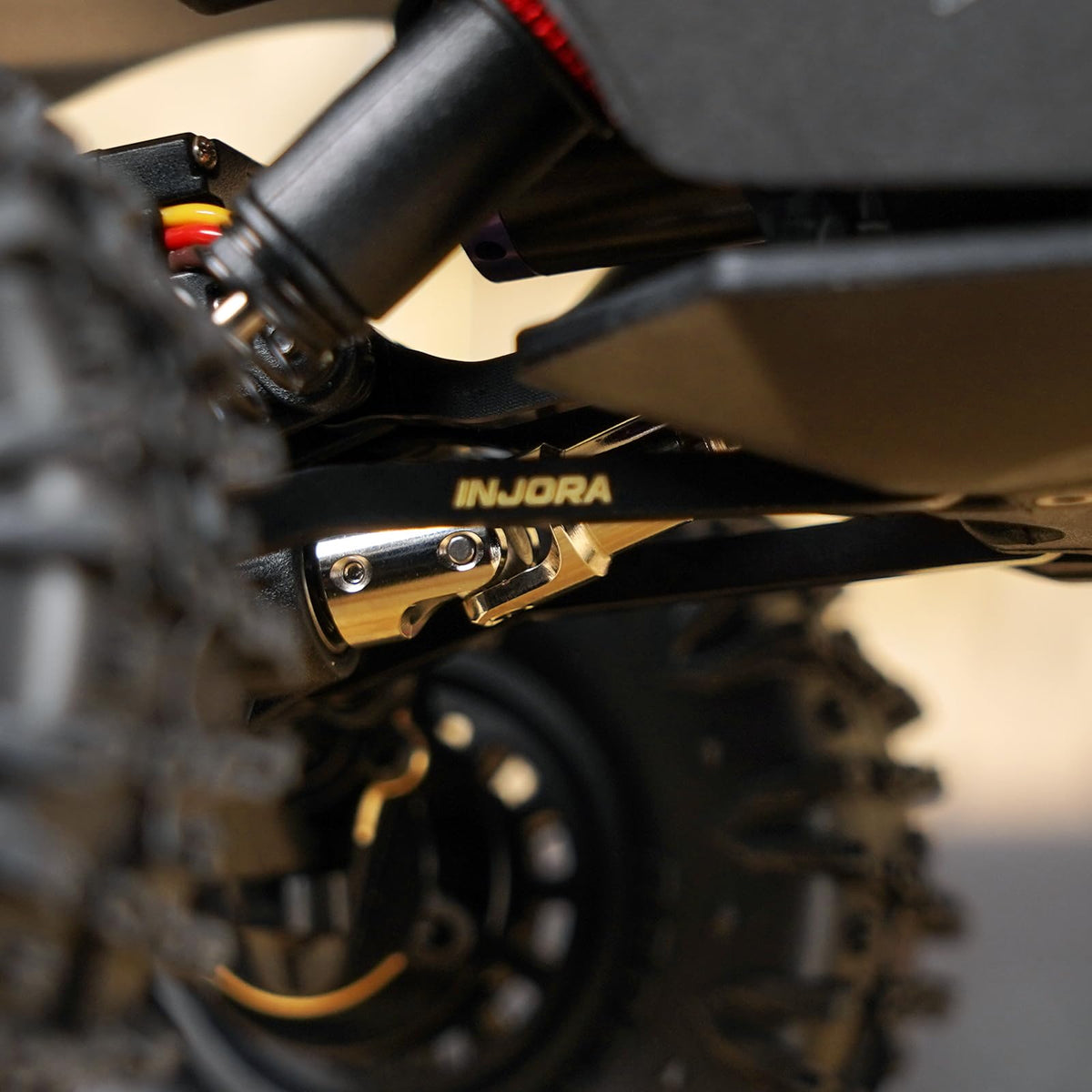 INJORA brass high-clearance links CNC detail shows precise fit for Redcat models