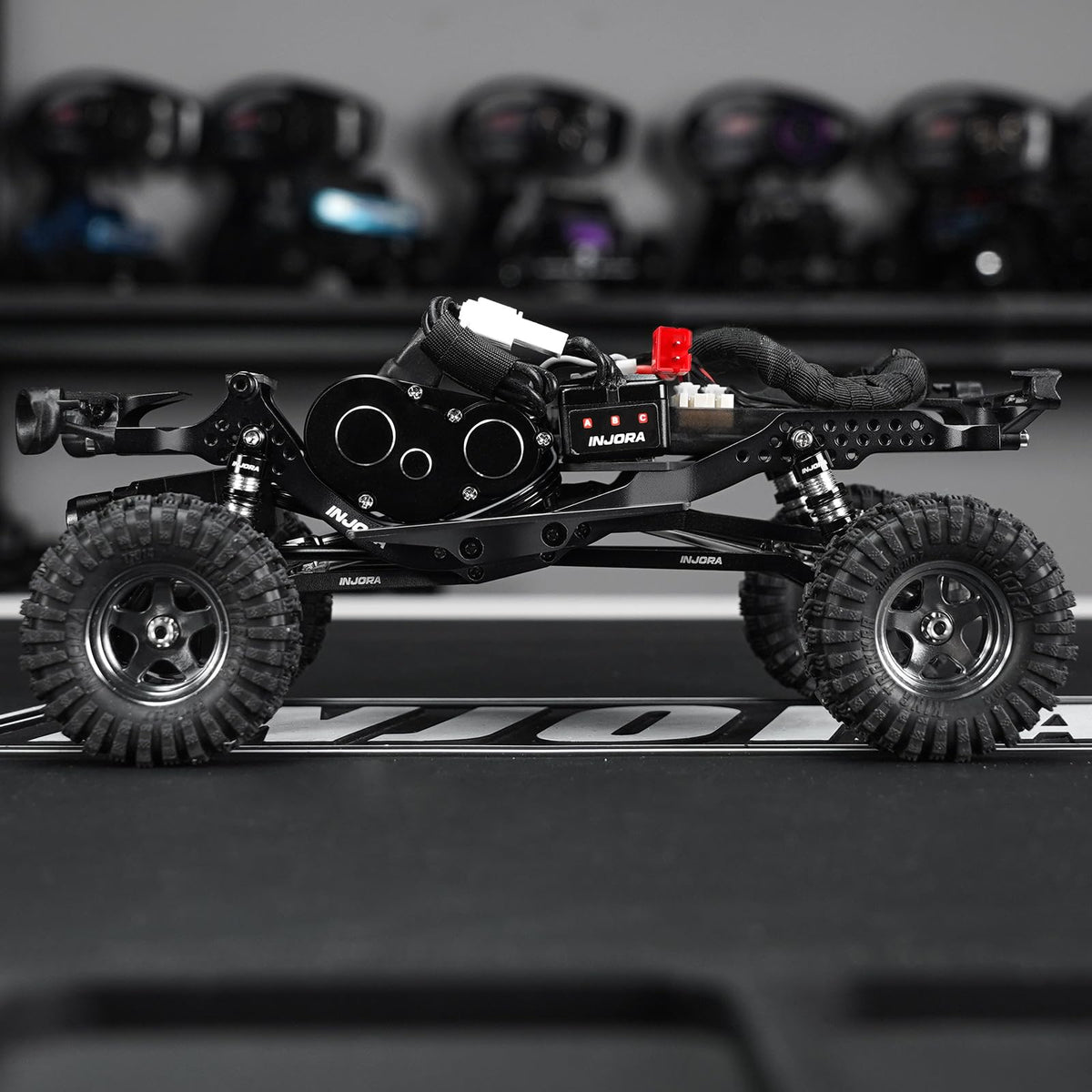INJORA LCG aluminum chassis climbing setup demonstrates stability on inclines