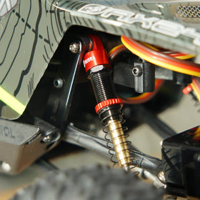 INJORA RC crawler red shocks for improved off-road performance.