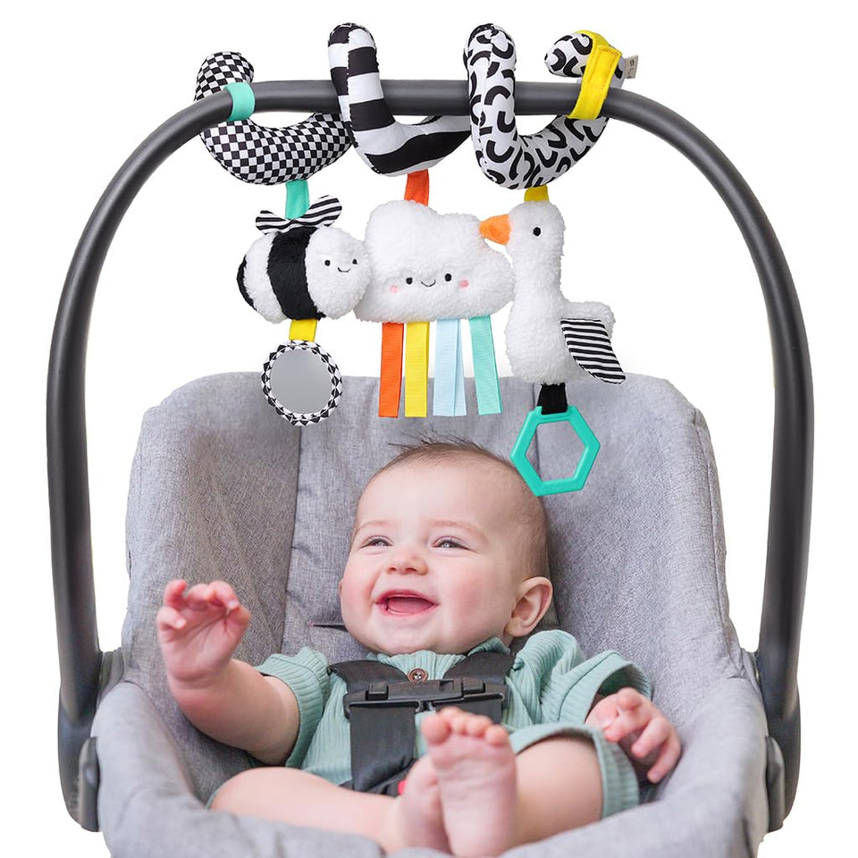 Itzy Ritzy Spiral Toy with a dangling ring encourages reaching and grasping on the go
