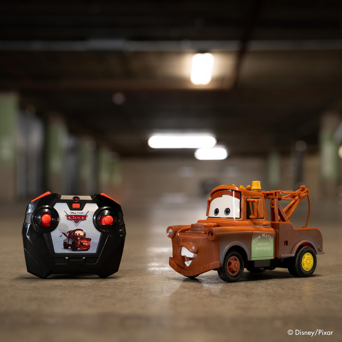 Jada Tow Mater RC turbo boost button enabling quick bursts during races.