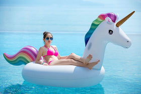 Two adults riding the Jasonwell unicorn pool float for a relaxed moment