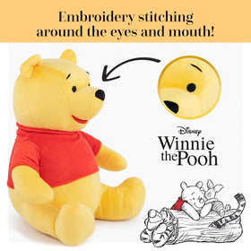 Winnie the Pooh pillow buddy shown in a cozy bedtime setup with plush friends