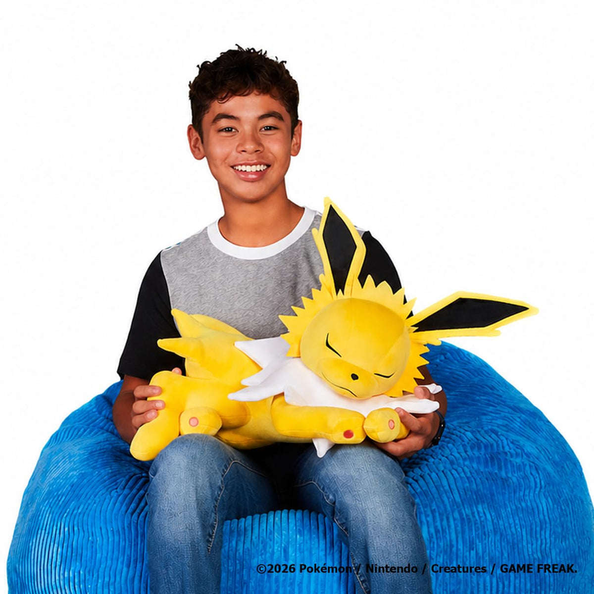 Jazwares Pokemon Jolteon sleeping plush 18-inch in a cozy pose for cuddling.