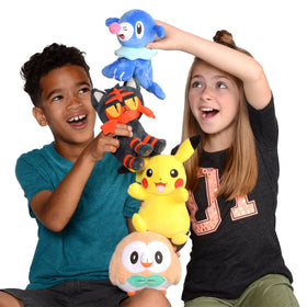 Litten plush displayed with other Pokémon for a collector setup.