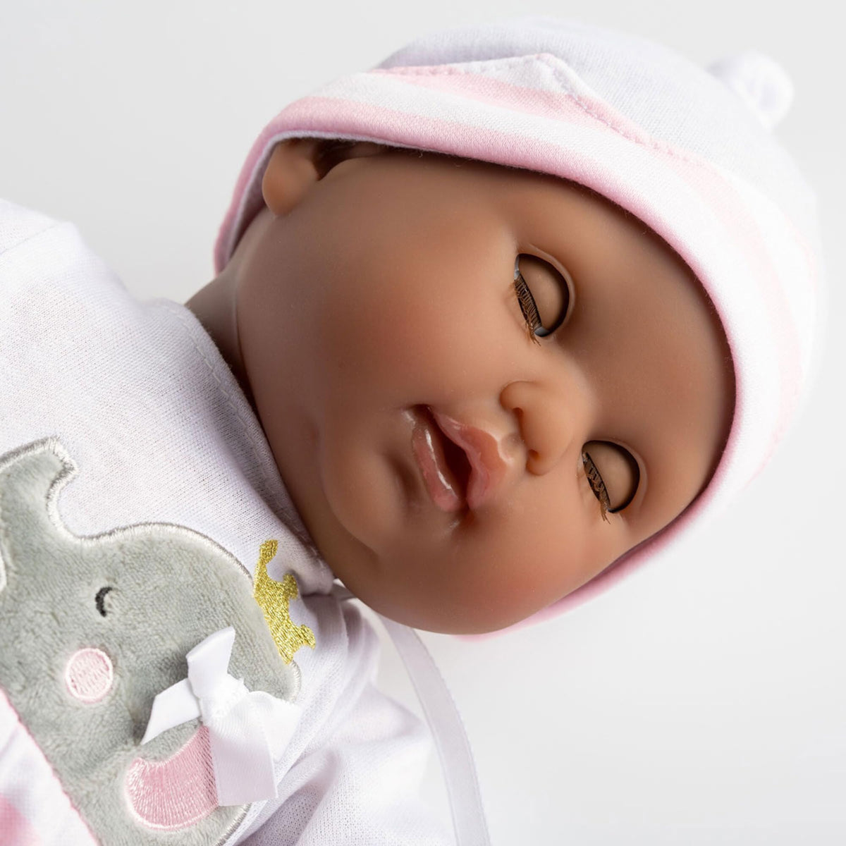 Embroidered outfit on doll highlighting realistic dressing activity by JC Toys.